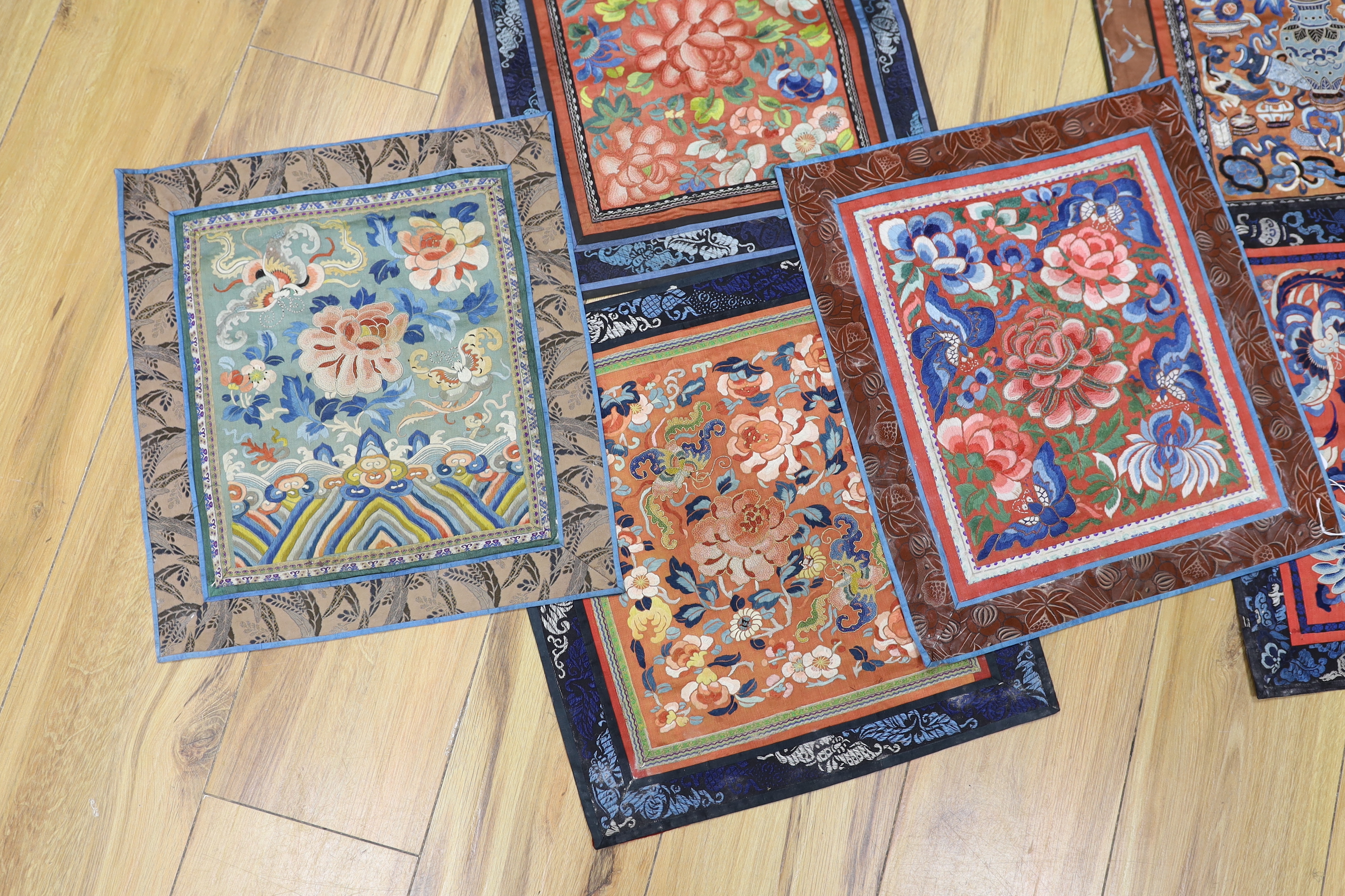 Six panels of Chinese silk embroidered mats, all using mixed stitches including Beijing knot, all bordered with silk brocade